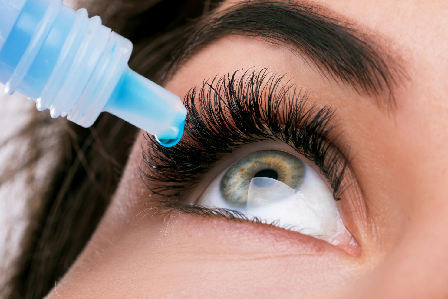 Close-Up Of Woman Putting Drip In Eye