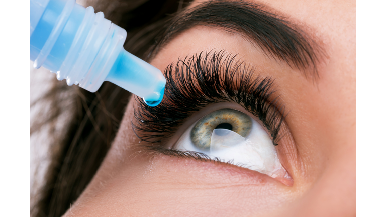 Close-Up Of Woman Putting Drip In Eye