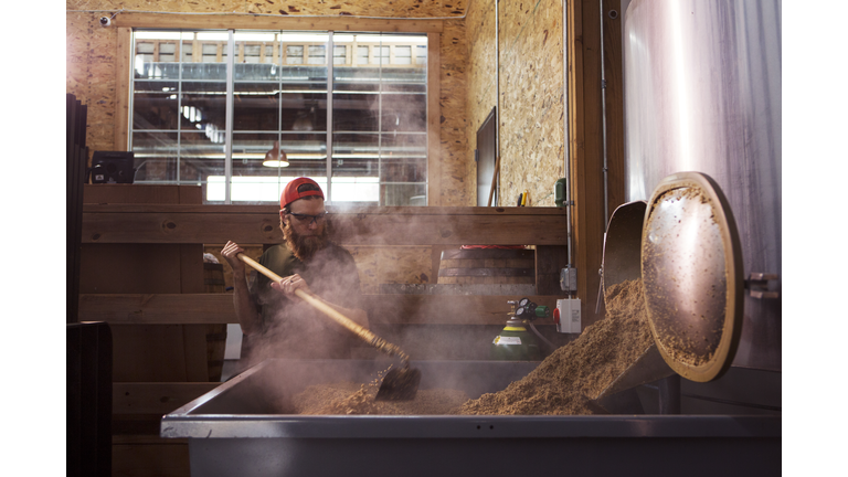 Brewer working on machinery at brewery