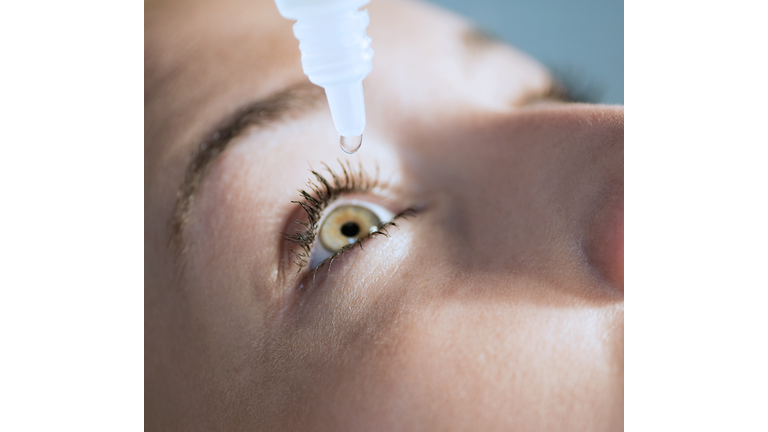 Eyedropper releasing fluid into an eye