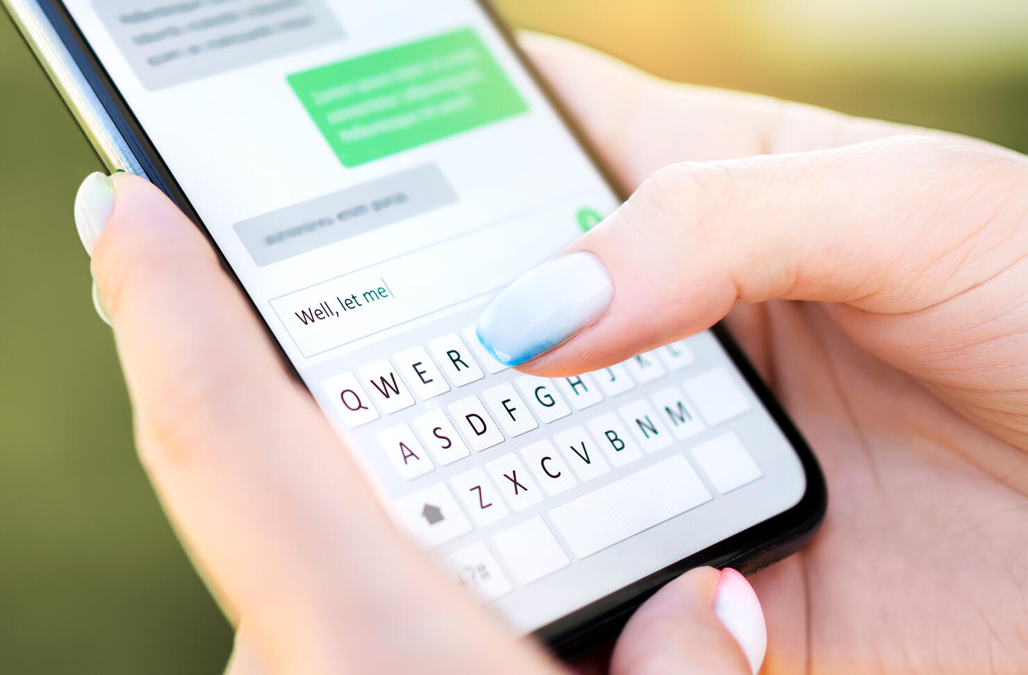 Text message with mobile phone. Woman texting sms with smartphone Catfish or digital scam. Screen keyboard in instant messaging chat. Macro close up of finger writing.