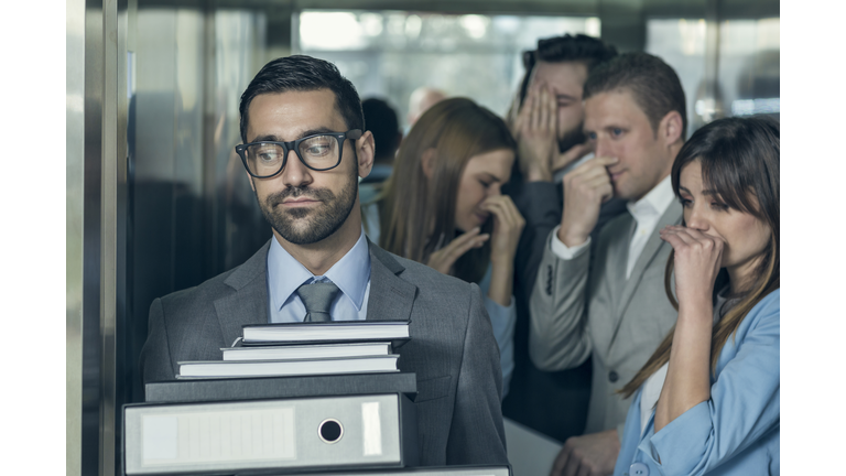 Smelly businessman affecting his coworkers in an elevator