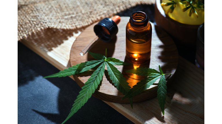 The dropper and bottle of cannabis oil on the table