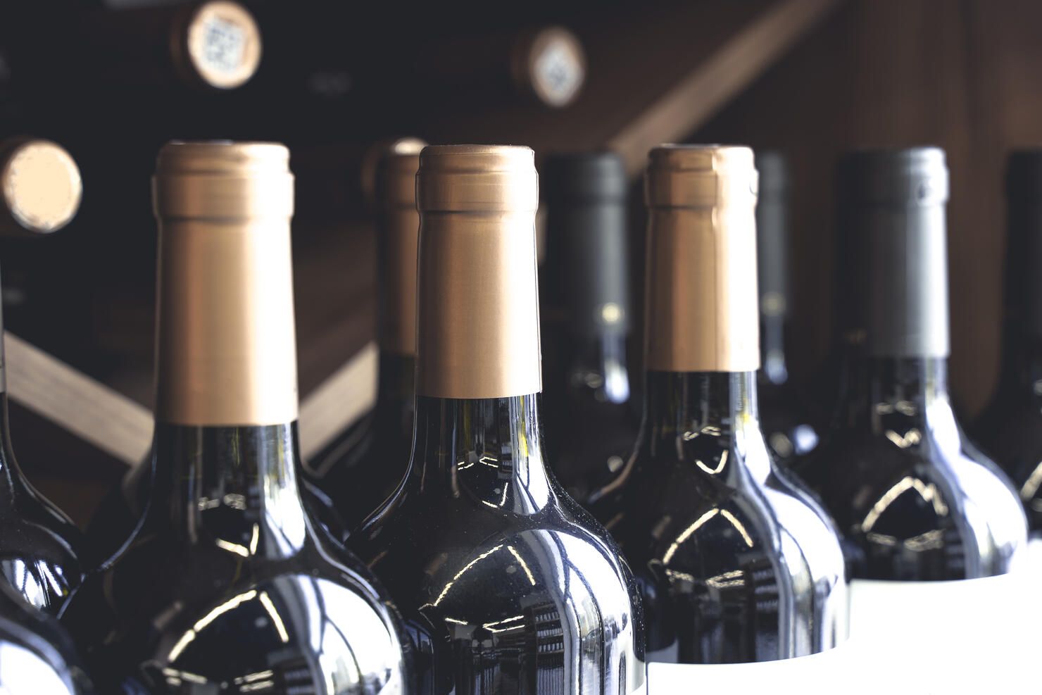 Wine bottles with blank labels on the counter of a liquor store. Wine background. Selected focus