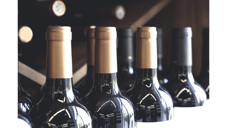 Wine bottles with blank labels on the counter of a liquor store. Wine background. Selected focus