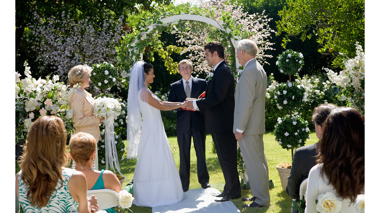 Bride and groom saying vows at wedding