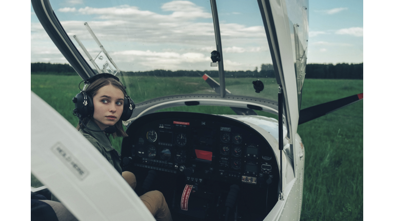 Caucasian woman sitting in airplane cockpit