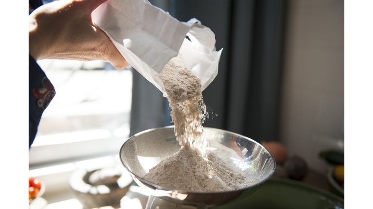 Making bread, weighing flour