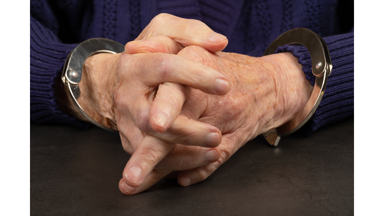 Handcuffed  elderly woman