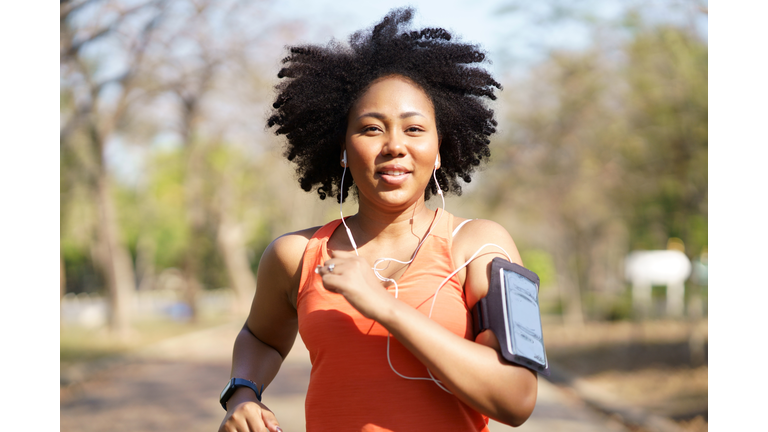 Young woman running exercise wearing heartbeat monitoring and smart watch