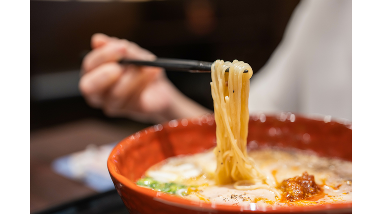 Close-up of ramen noodles in red bowl on table