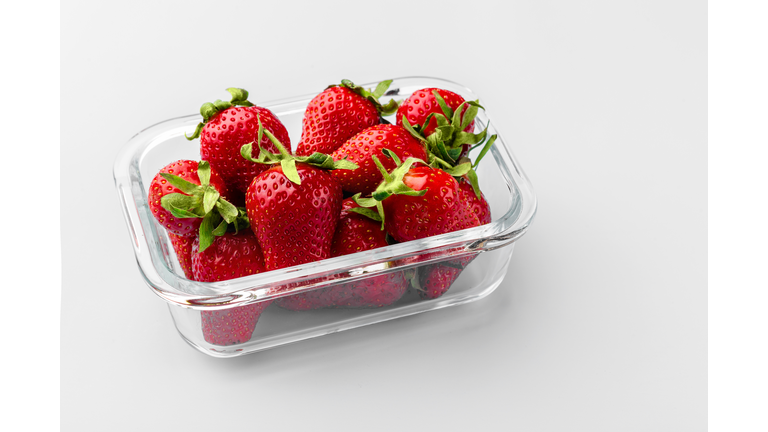 Glass box with fresh strawberries.  Vegetables in a glass containers. Food storage concept