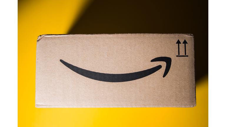 Amazon Prime cardboard box delivery yellow background