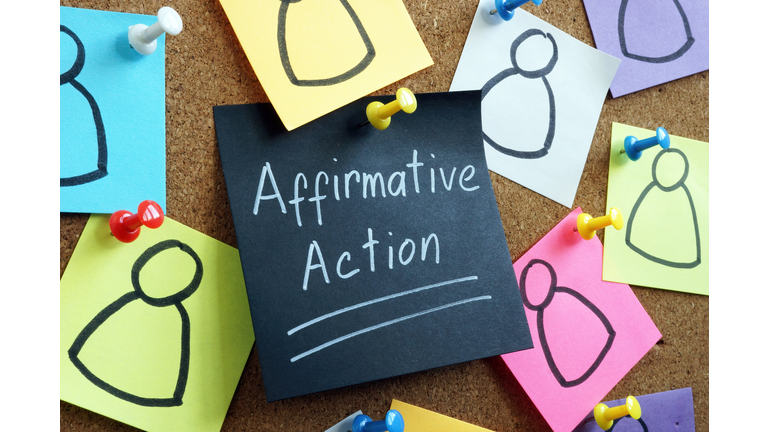 Affirmative action concept. Memo stick pinned to the board.