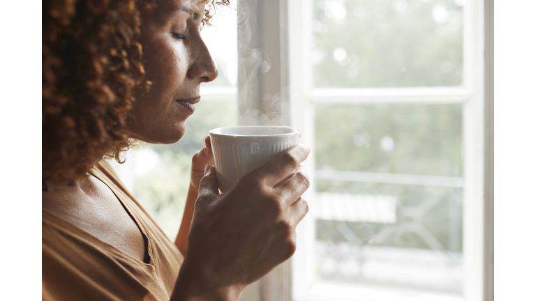 Woman smelling coffee