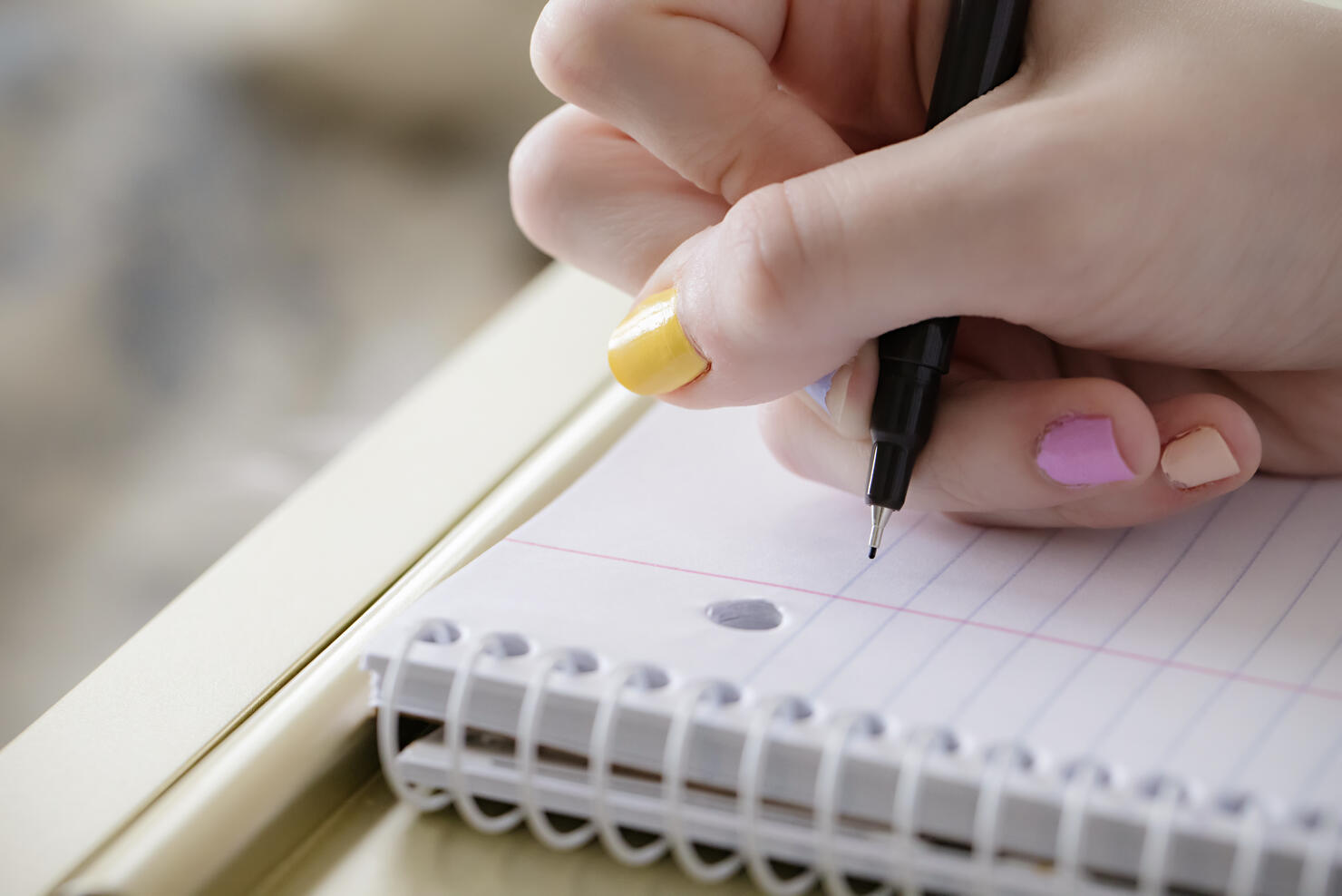 Teen girl beginning to take notes during virtual school