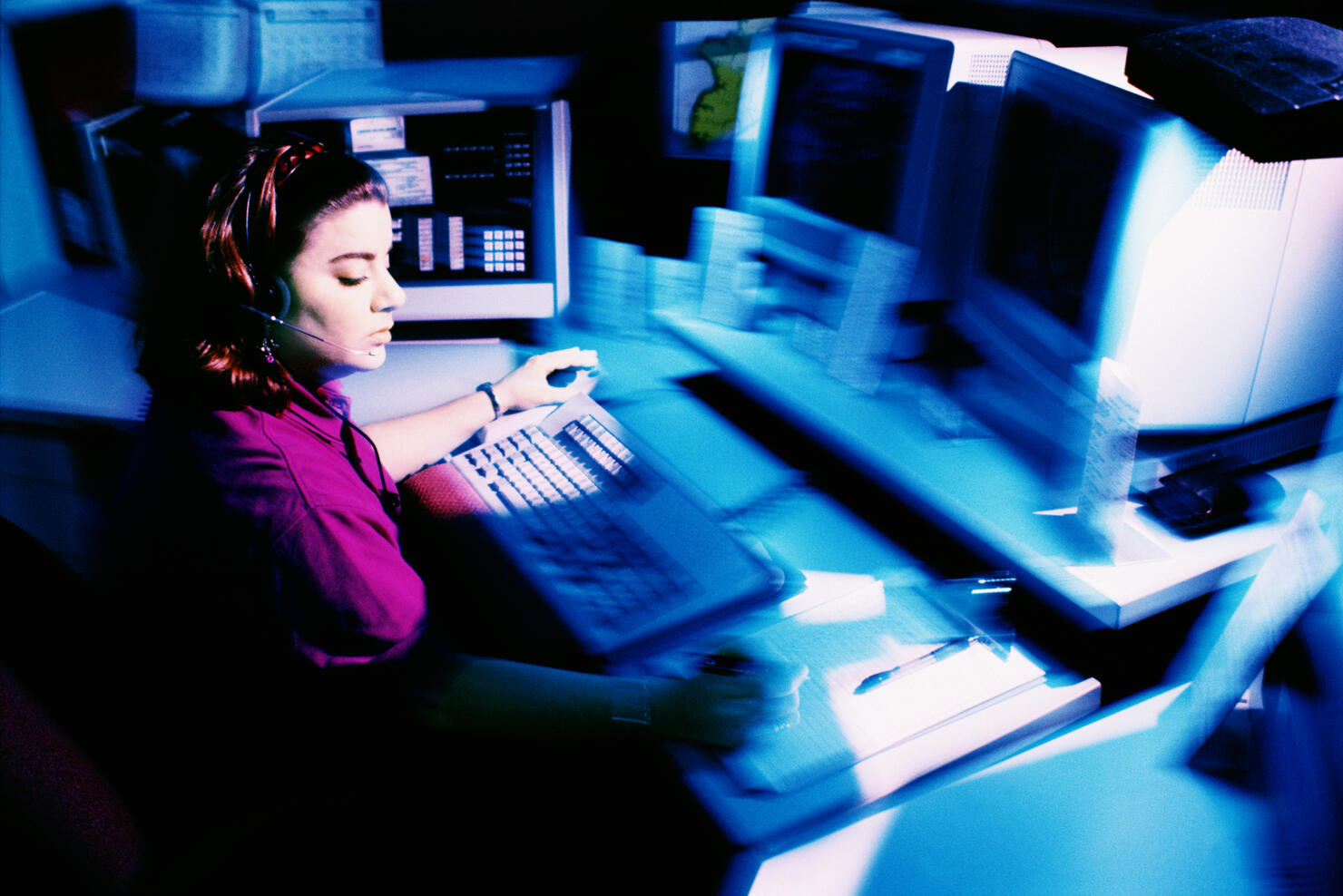 Woman working at police dispatch terminal