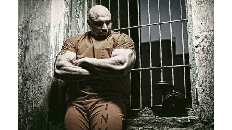 Muscular Man Standing In Prison