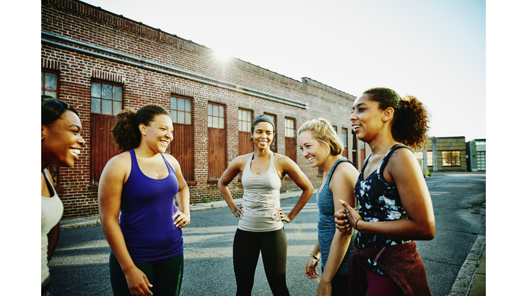 Laughing group of women resting after run