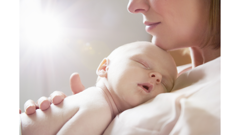 baby sleeping on mother's chest