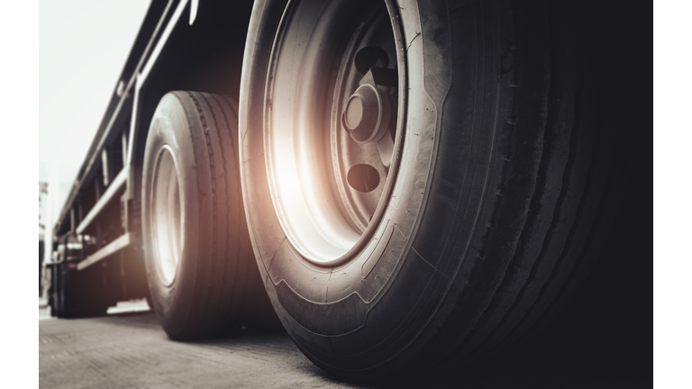 Freight transportation. Close-up large a truck wheels and tires of semi truck.