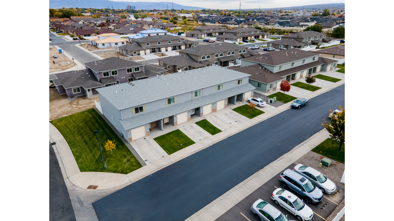 Aerial Drone View Of Condominiums, Townhomes With Attached Garages And New Single Family Homes Under Construction real estate, Affordable First Time Home Buyers, Rental Units