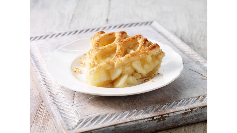 Brambly apple pie slice on wooden chopping board