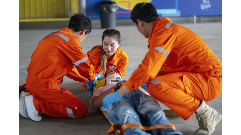 asian paramedic who is a full-time ambulance staff are providing first aid to the accident victims send to the hospital for further treatment.