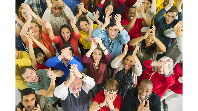 Portrait of diverse crowd clapping