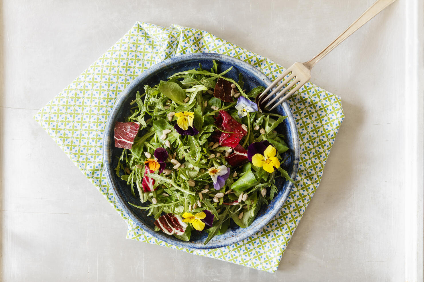 Bowl with salad, lamb's lettuce, rucola, radicchio and edible flowers