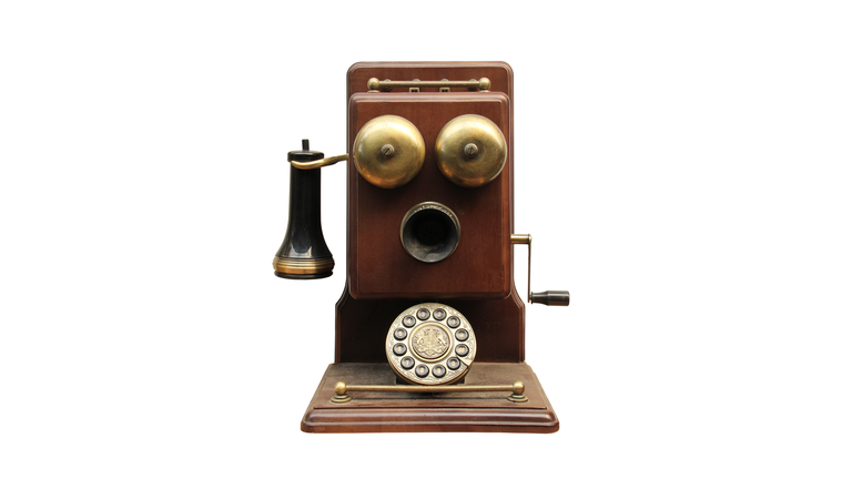 Close-Up Of Antique Telephone Over White Background