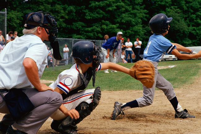 Little League batter swinging at ball