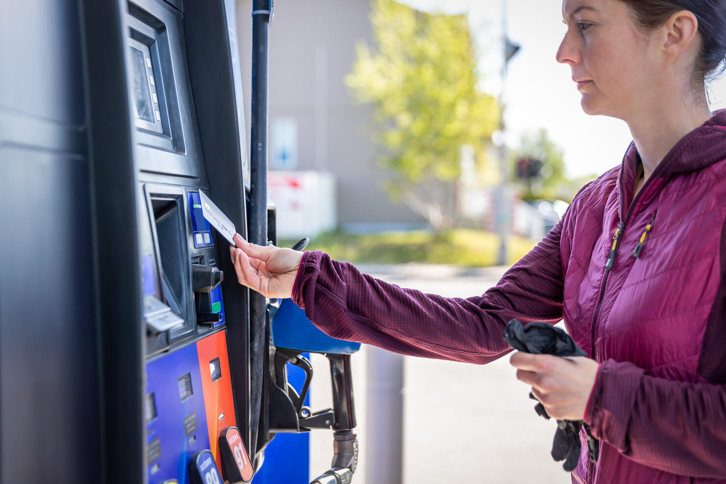 Woman Paying at Fuel Pump at Gas Station With Contactless Payment