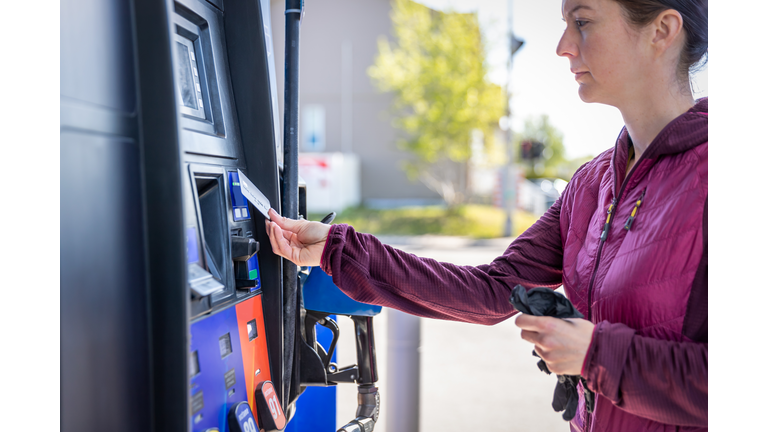 Woman Paying at Fuel Pump at Gas Station With Contactless Payment