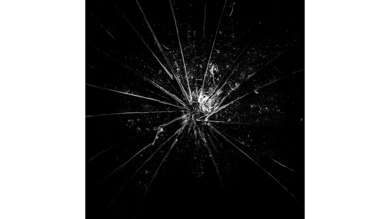 Broken glass background in black. Black minimalist background with cracks on the glass with water droplets. Abstract black minimalism.