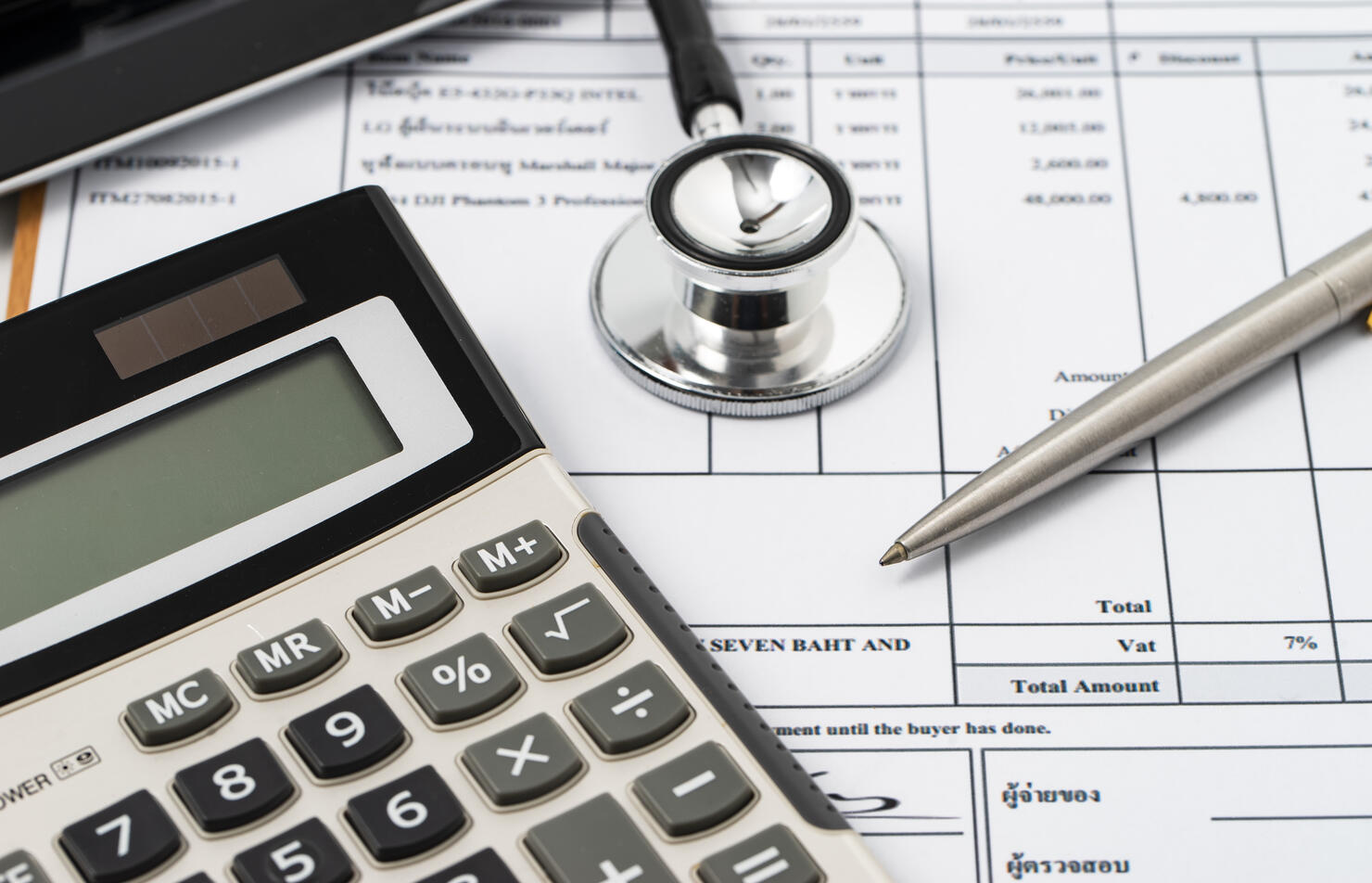 Stethoscope on medical billing statement on table, all text is anonymous