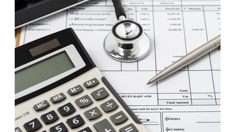 Stethoscope on medical billing statement on table, all text is anonymous