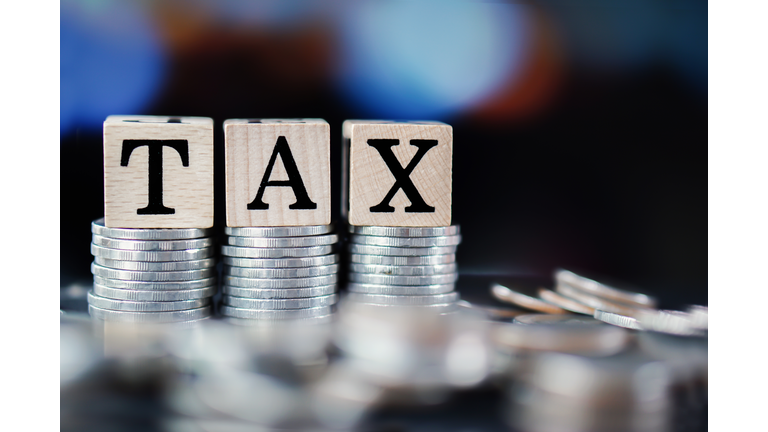 Tax Time Concept With Tax Word And Stack Of Coins