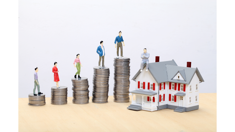 Stack of coins and model house, Concept of money savings
