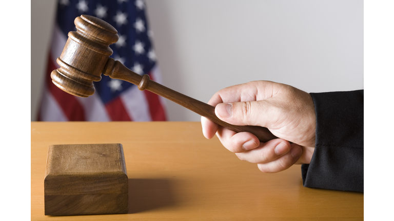 Judge hitting sound box with gavel