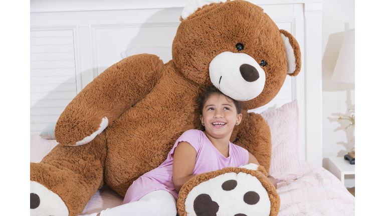 Little girl with giant teddy bear