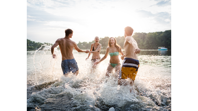 Young Couples Running In Lake