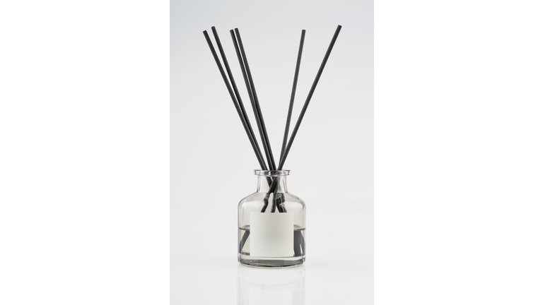 Home fragrance diffuser with wooden sticks isolated on white background