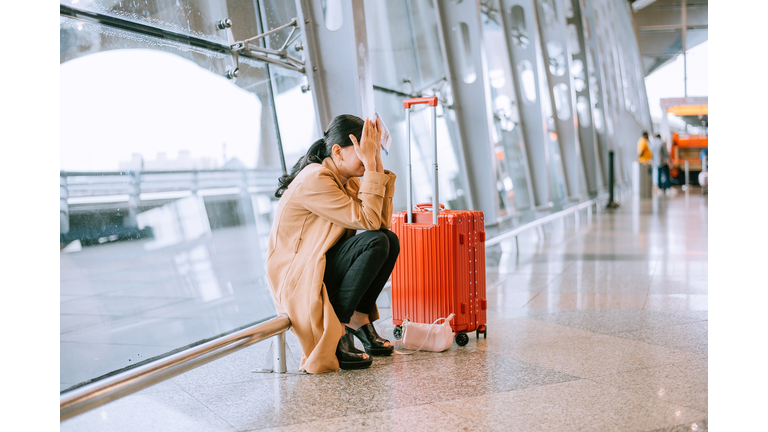 Young Asian woman upset and frustrated while flight canceled at the airport