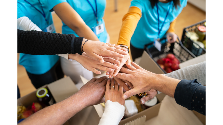 Volunteers hands stacking in a circle