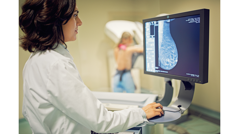 Doctor is working with mammography X-ray scanner in hospital