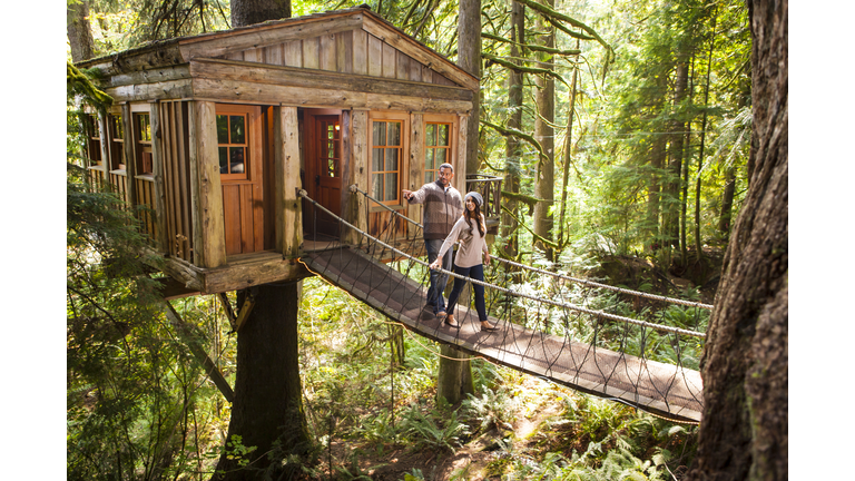 Couple on walkway of remote tree house