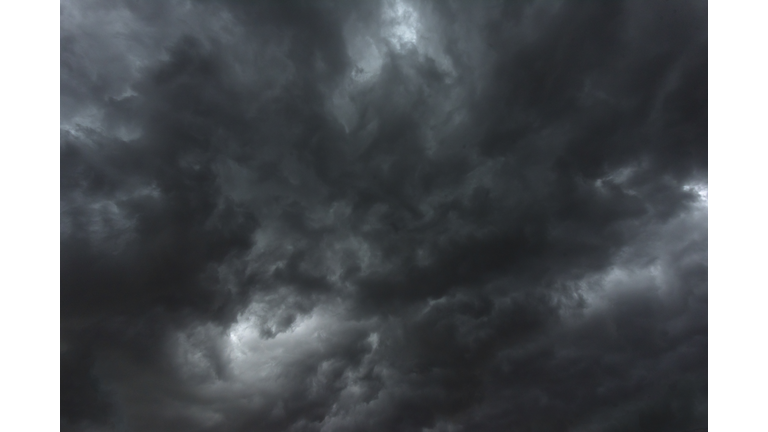 Dramatic dark storm rain clouds black sky background. Dark thunderstorm clouds rainny atmosphere. Meteorology danger windstorm disasters climate. Dark cloudscape storm disaster gloomy gray cloud sky