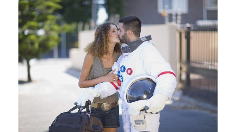 Woman kissing an astronaut