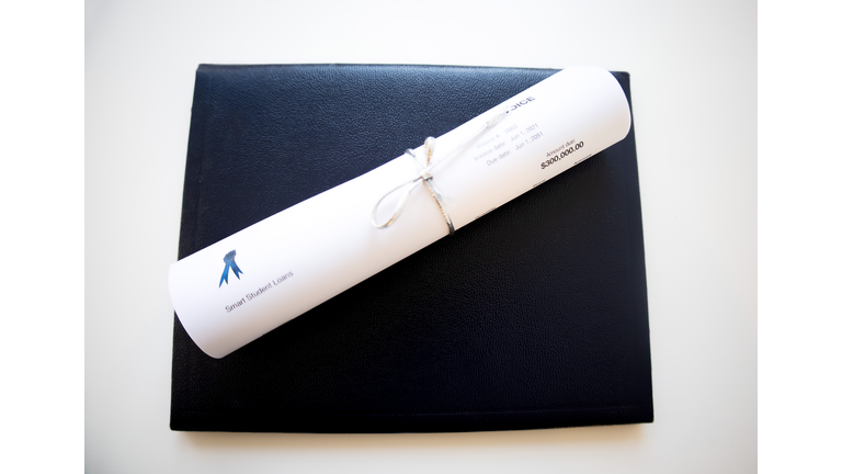 traditional leather diploma binder & “invoice” for student loan payment rolled up as a certificate